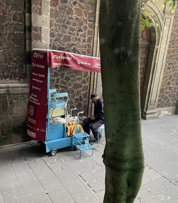 A shoe-shiner and his protable workshop, Mexico City.