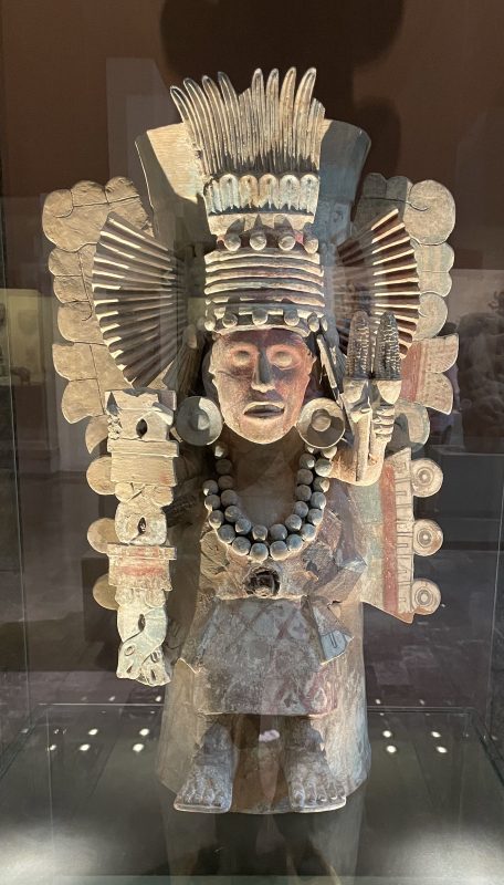 A statue of a man in ceremonial attire. Note the elaborate headdress.