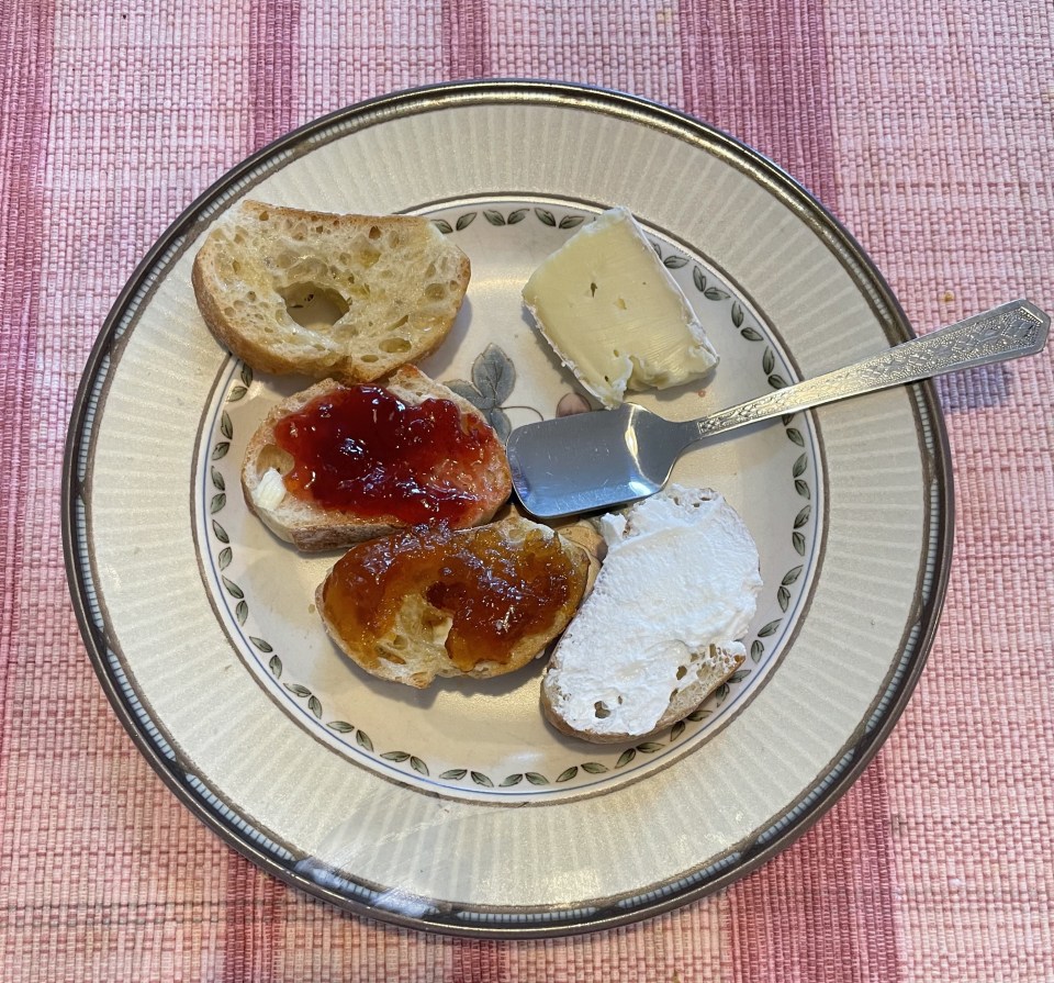 Breakfast plate with bread, preserves and cheese.