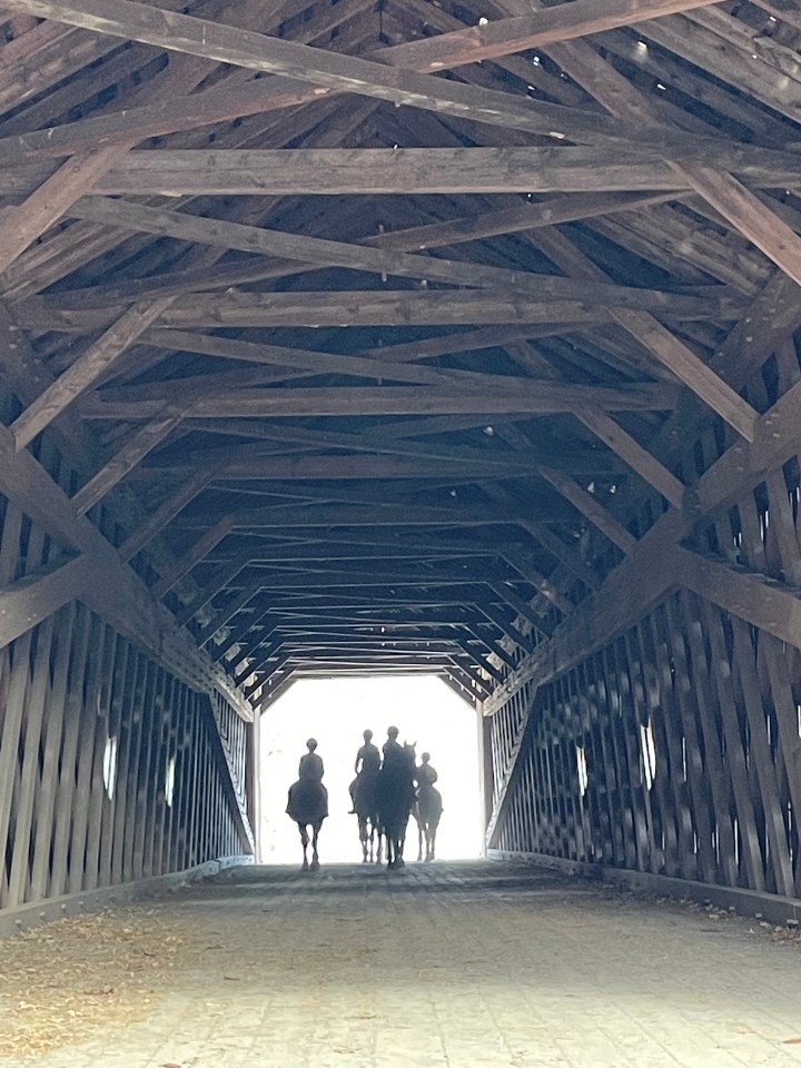 Equestrians crossing the Schofield Covered Bridge, Tyler State Park.