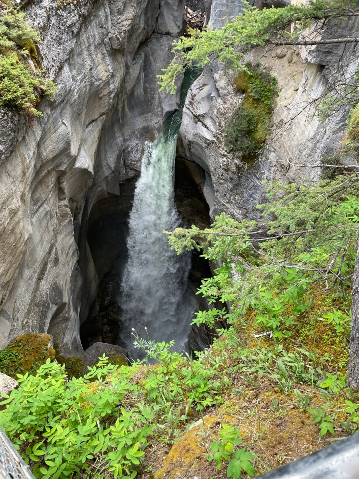 The waterfall in Maligne Canyon pouring over a narrow gorge, Jasper National Park, Canada.